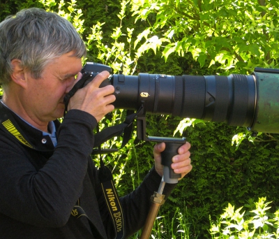 Voor m'n 500 mm F/4 van 4 kg heb ik de veerdruk zo gekozen dat de veer bijna helemaal is ingedrukt in horizontale rustpositie. Je hoeft dan niet meer te tillen; alle gewicht rust op de heupen via de draagriem. Door de vering worden schokkerige bewegingen gedempt.